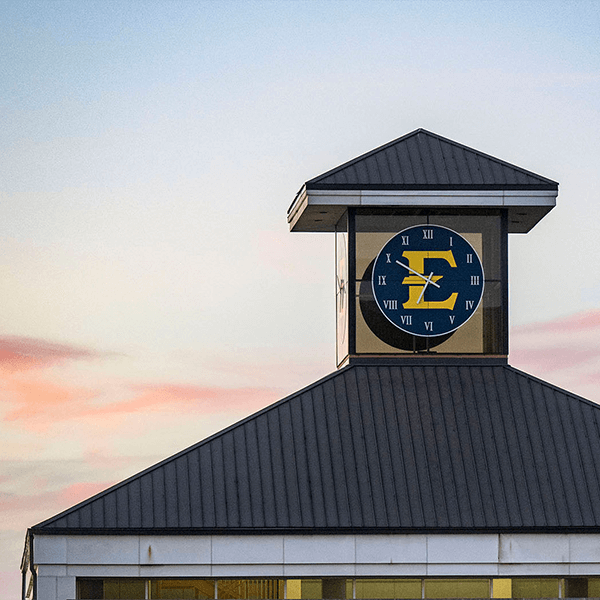 Clock tower on ETSU's campus against pink sky backdrop