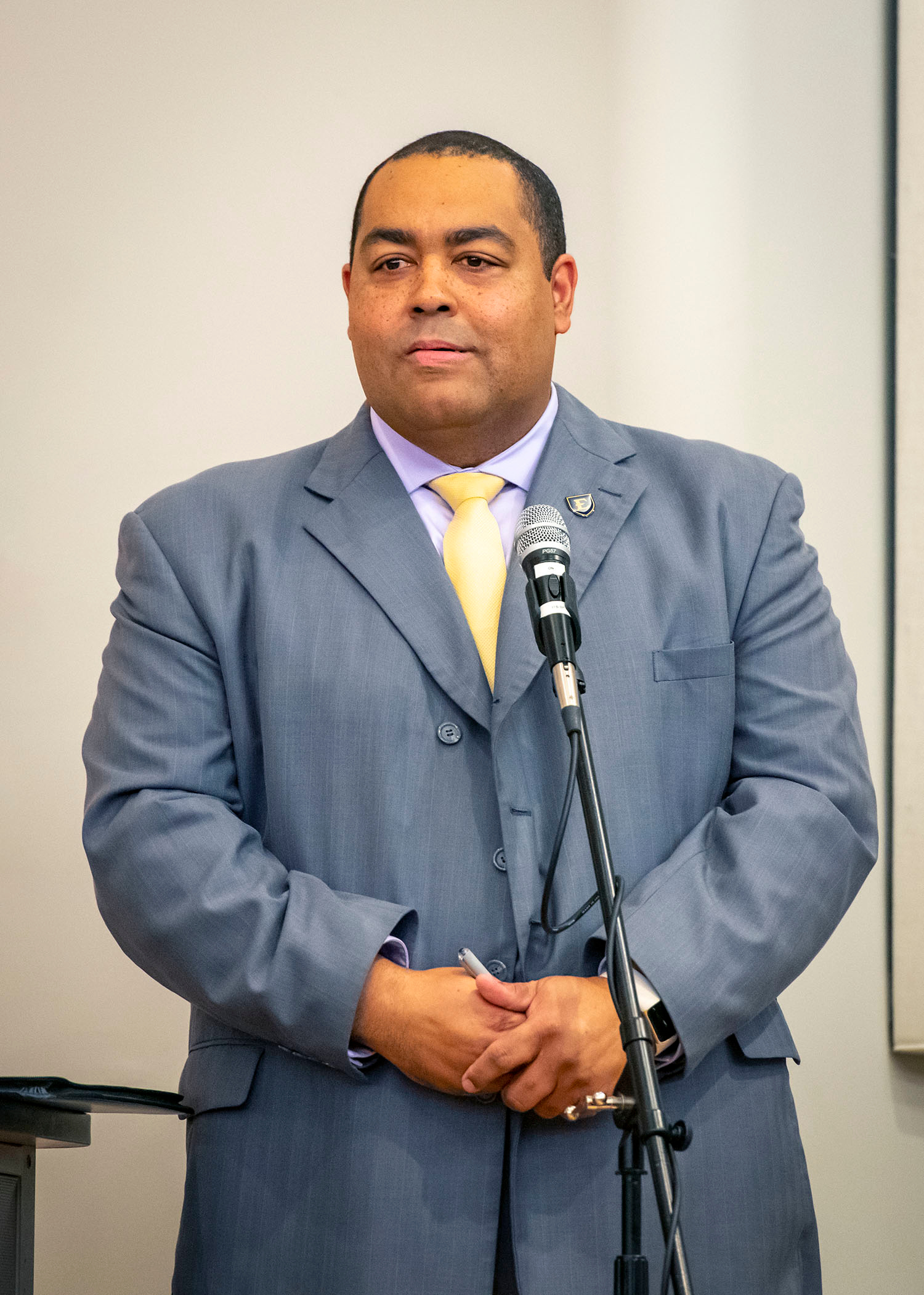 Dr. Daryl Carter standing in front of a microphone.