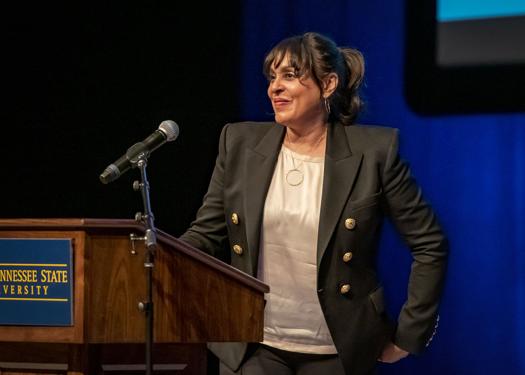 Natasha Trethewey smiling and standing at a lecturn