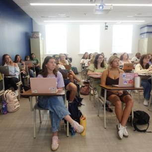 Students are listening to their instructor during a Math 1410 class.