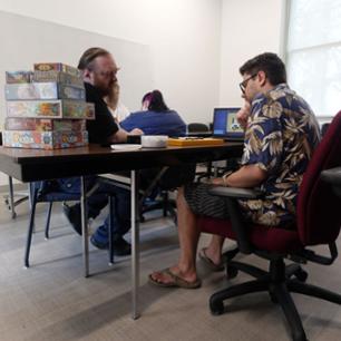Prof. Buck and a student playing a board game.