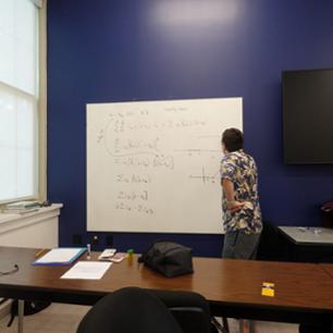 Student working on a math problem in math club.