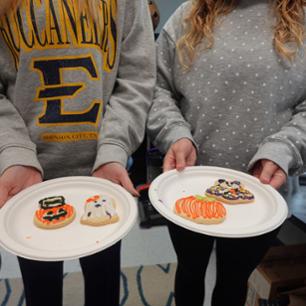 Students worker on spooky cookies.