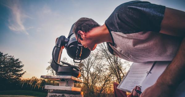 A student using a telescope to stargaze