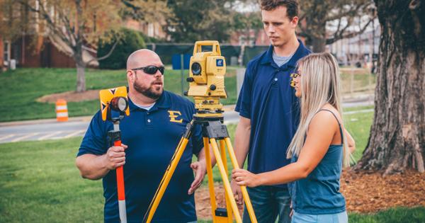 ETSU students and professor using surveying equipment