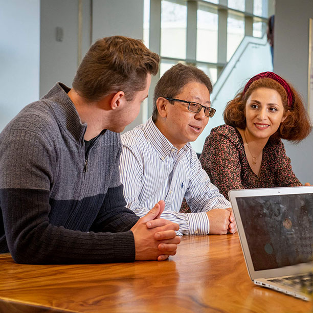 marketing students in discussion with professor