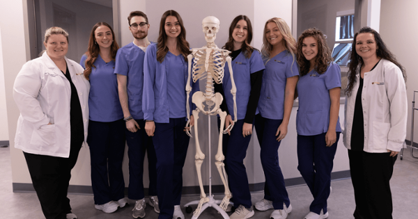 radiologic students posing with skeleton