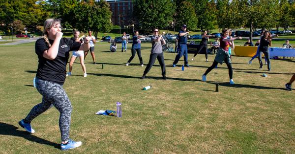 Group fitness class exercising outside ETSU's Center for Physical Activity