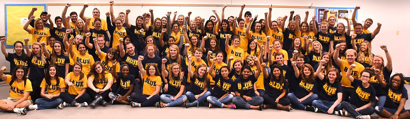 students wearing ETSU t-shirts, cheering