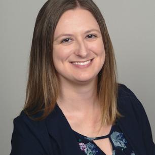 Amanda Frasier smiling broadly with her hair down and dressed in a black shirt.  of Amanda Slaten Frasier