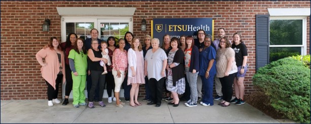 A group photo of the faculty and staff at the clinic.