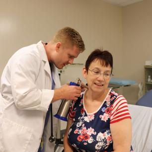 Doctor examining a little girl