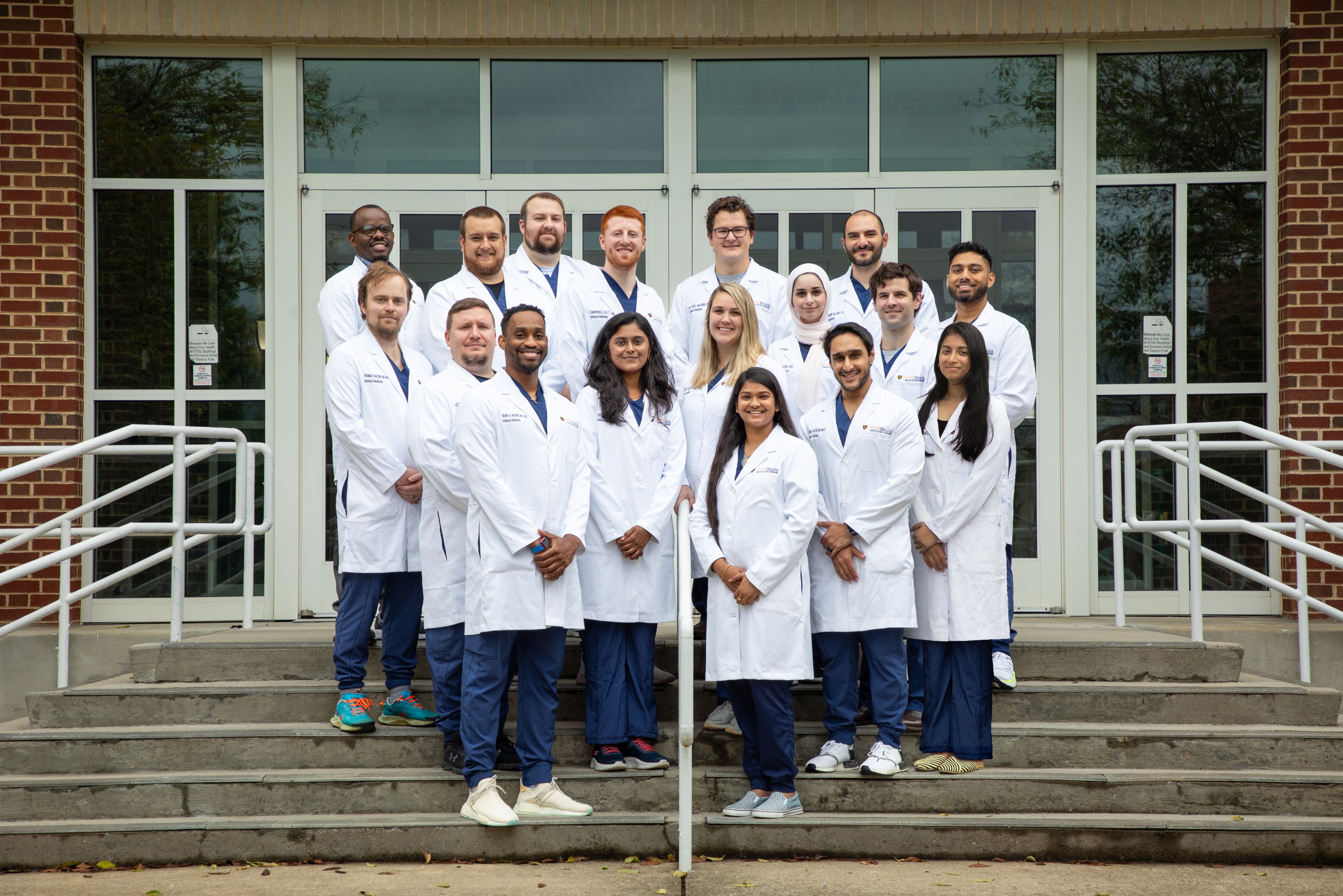 Group photo of second year residents standing on steps