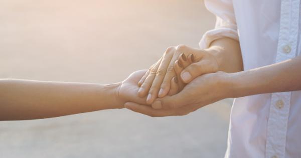 two people lightly hold hands