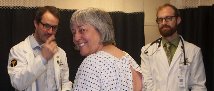 Two medical students talking to a patient.