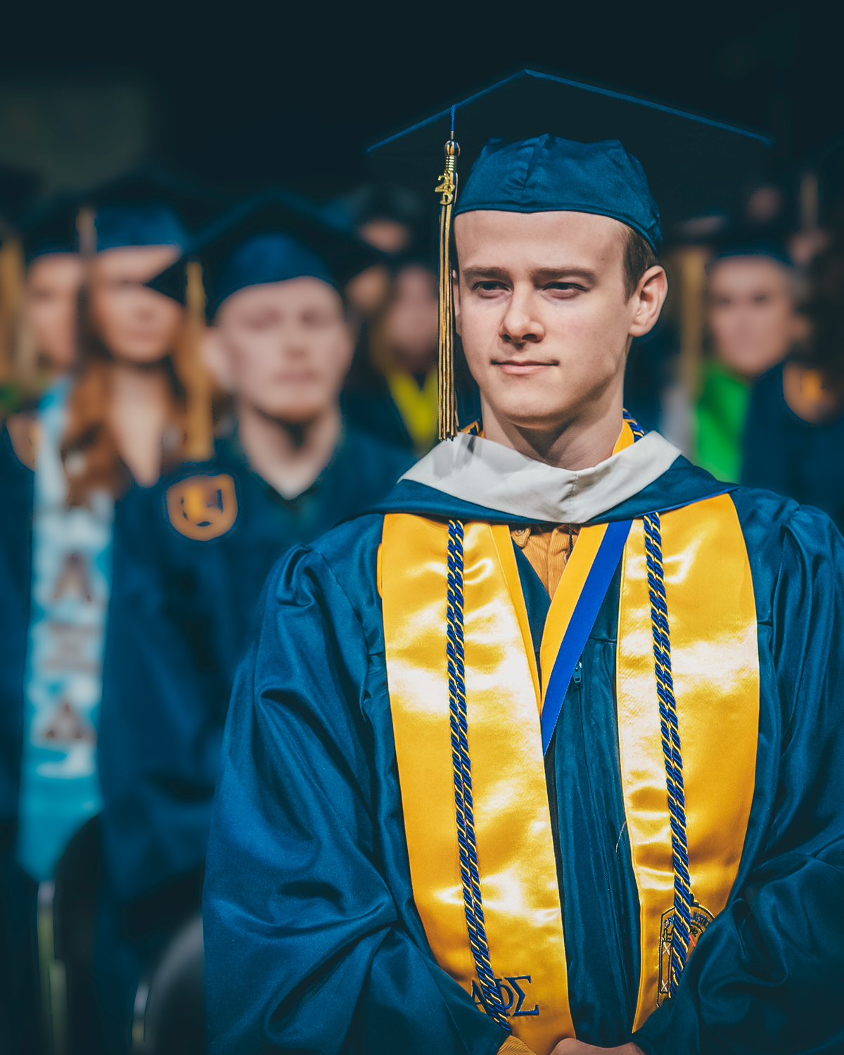 Graduates of the ETSU's Class of 2024 stand in line at commencement, waiting to cross the stage