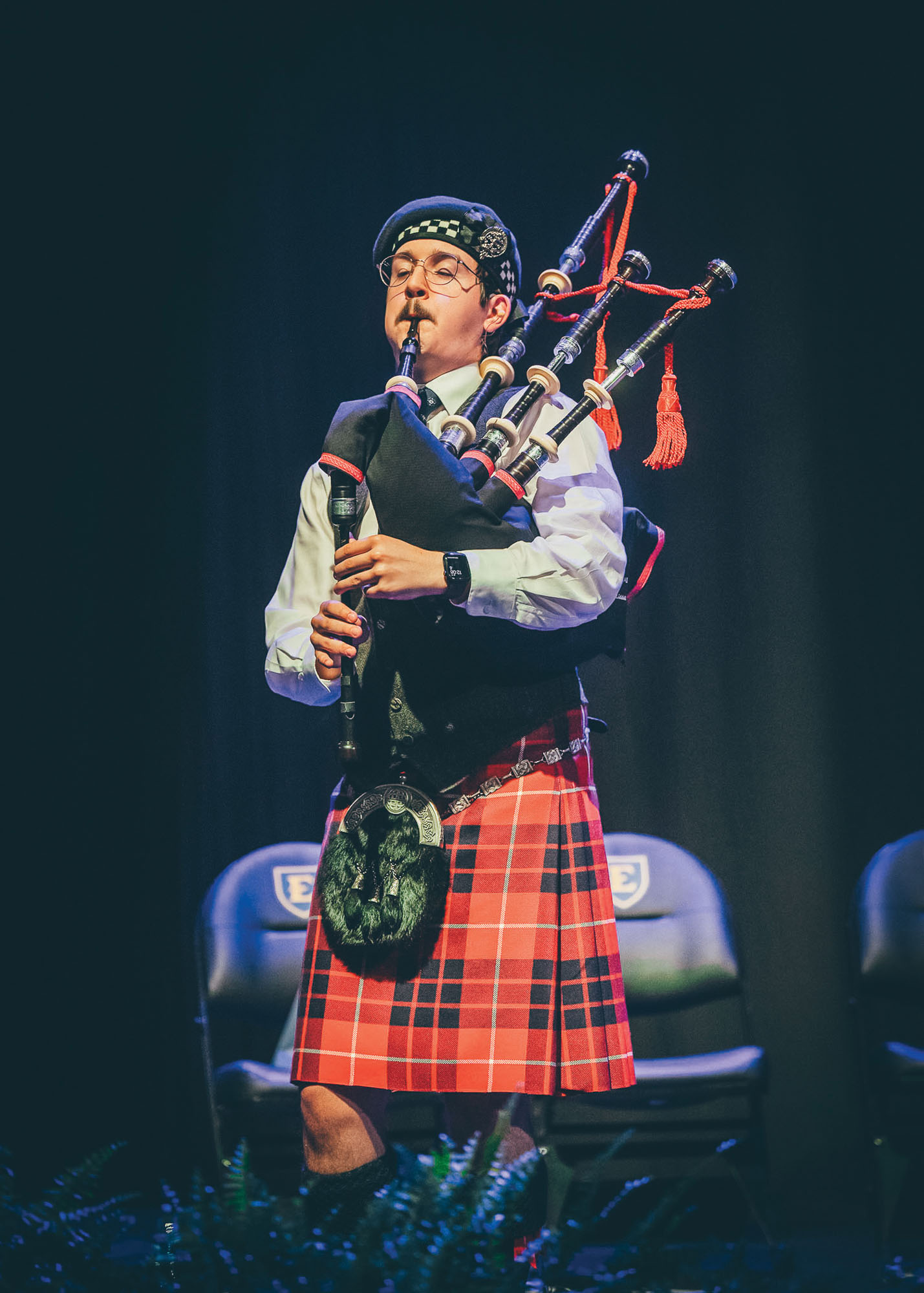 a bagpiper plays their instrument.