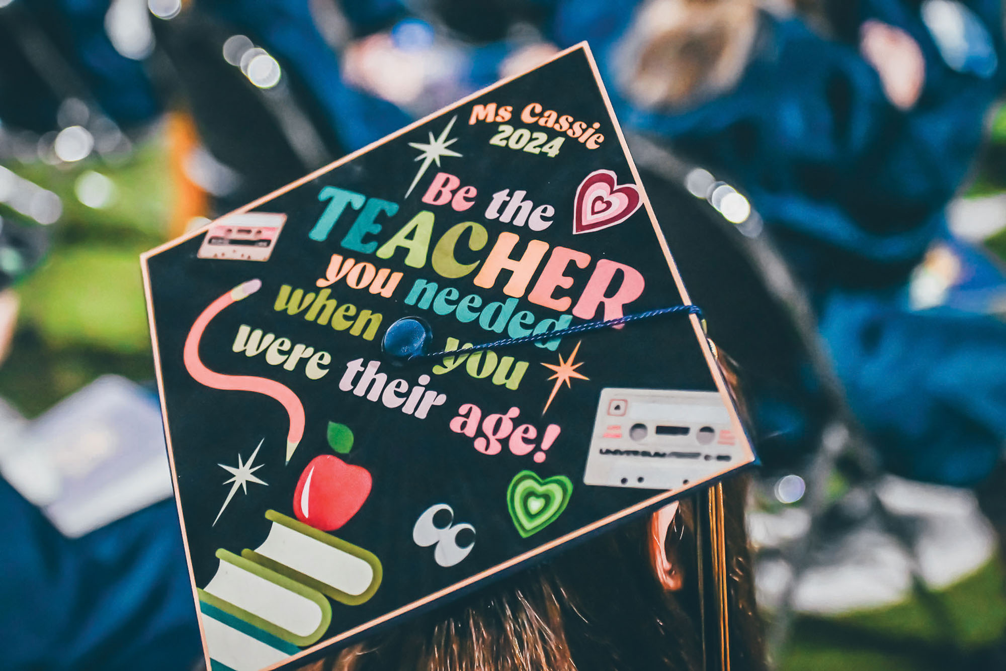 decorated graduate cap that reads “Ms. Cassie 2024, Be the TEACHER you needed when you were their age!”