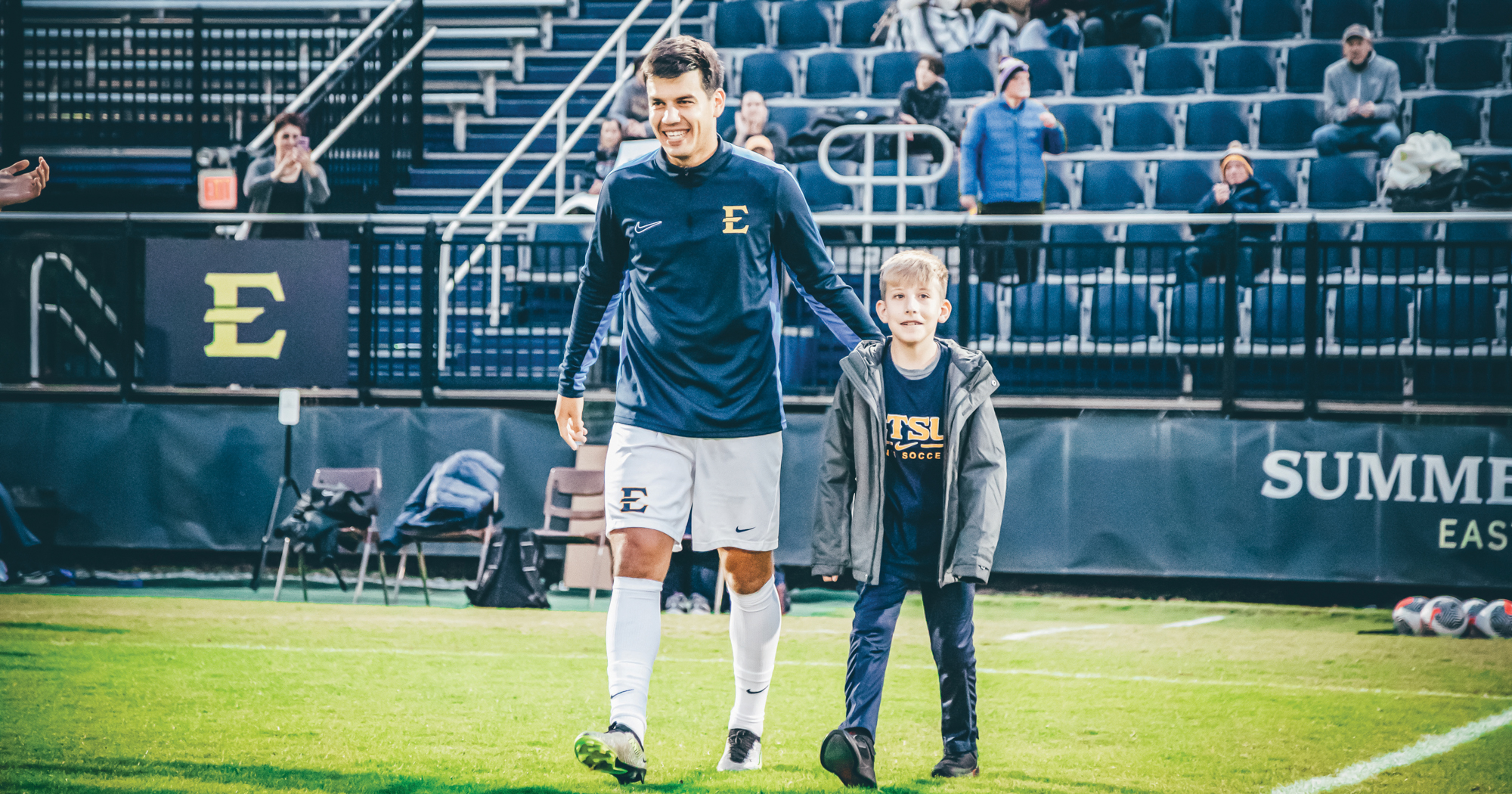 Landon Knack walks on field at Summers Taylor Stadium with an ETSU Men's Soccer Player