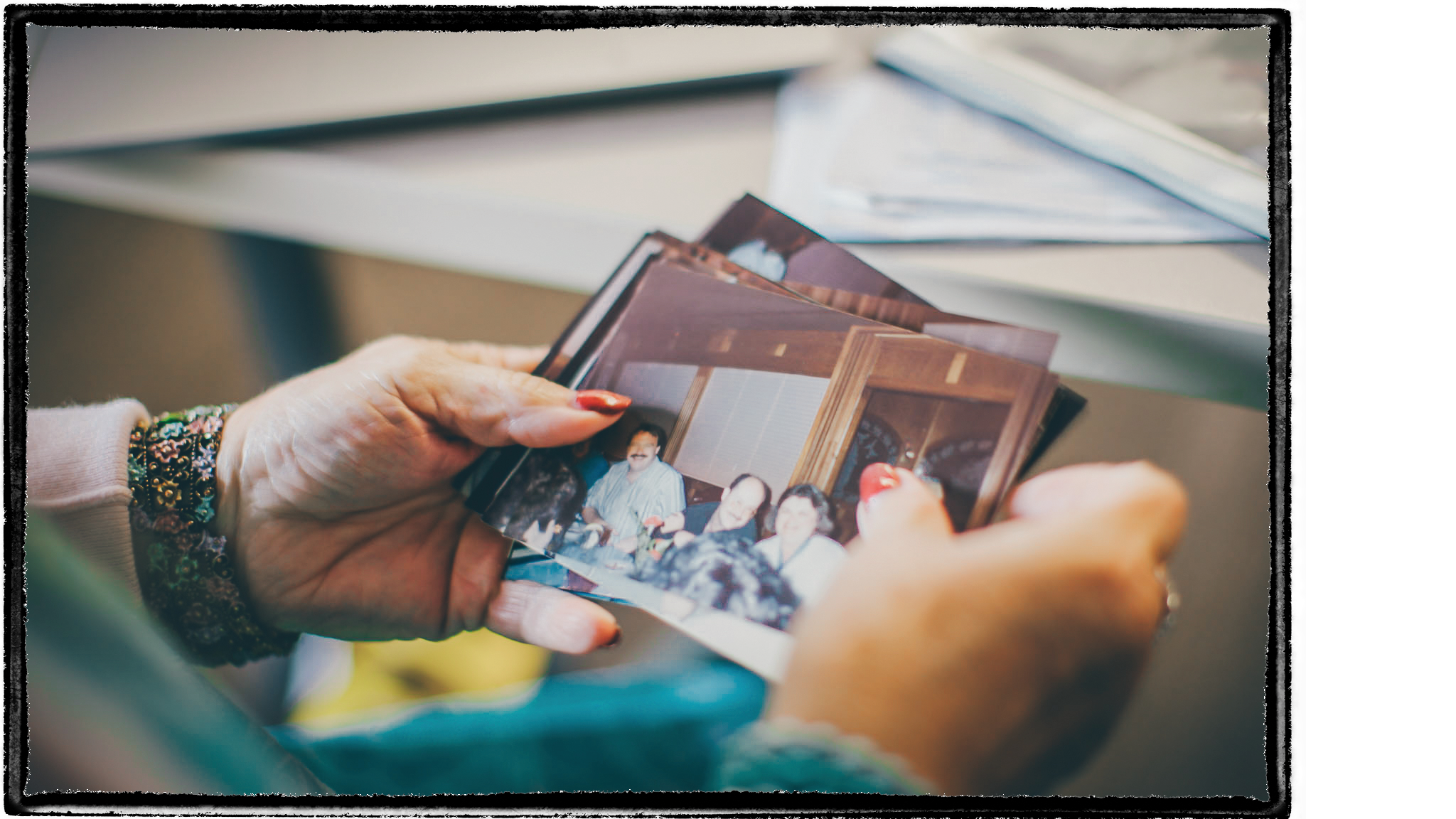 Two hands of a person sorting through photos.