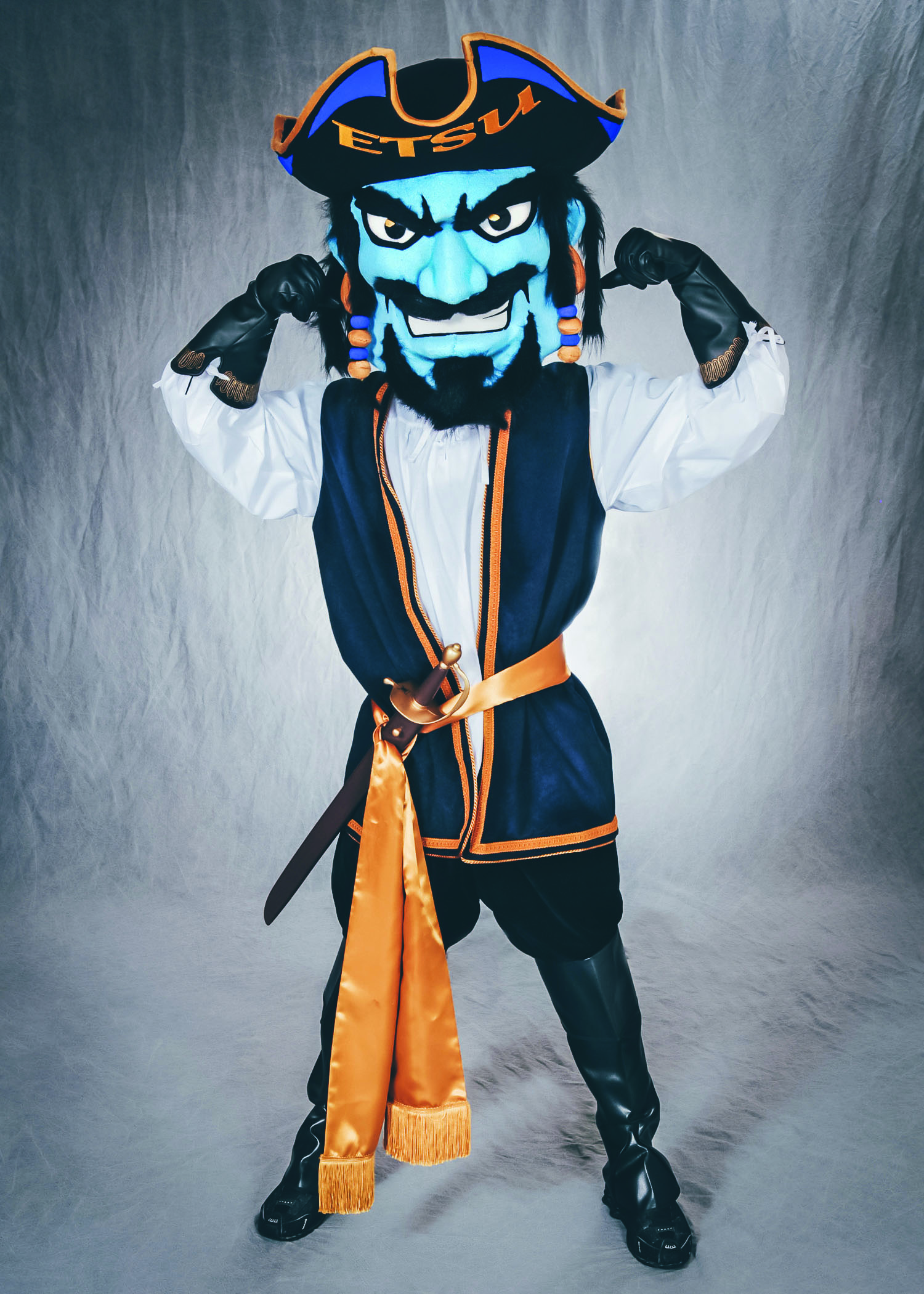 An earlier version of Bucky, ETSU’s mascot, flexing both of his arms and smiling