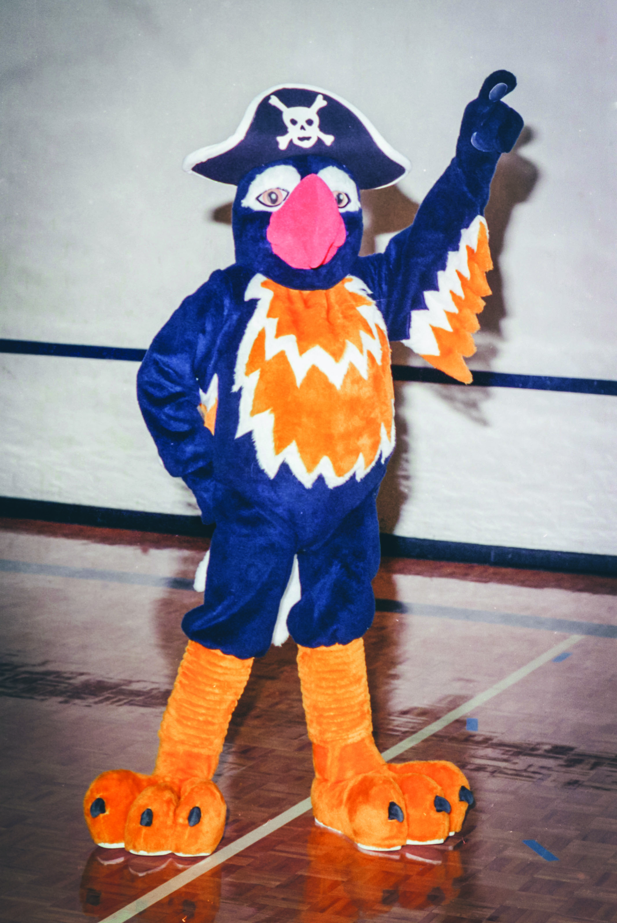 Pepper the Parrot holding a hand up and posing for a photo