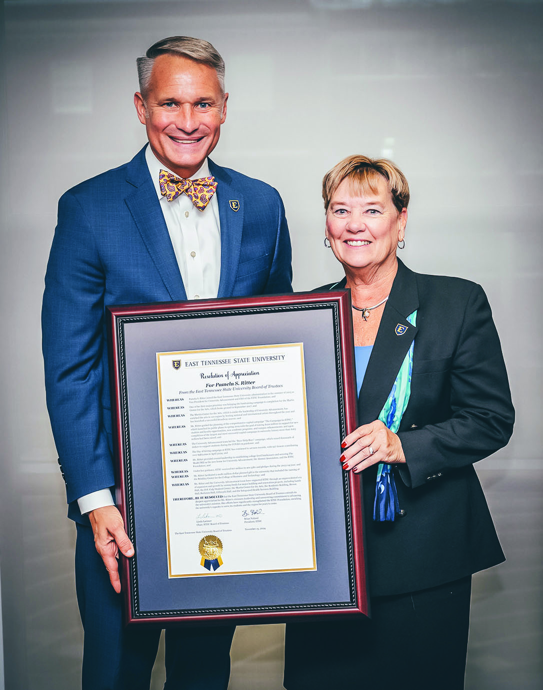 President Dr. Brian Noland presents a Resolution of Appreciation to Pam Ritter at the Board of Trustees meeting on the occasion of her retirement.