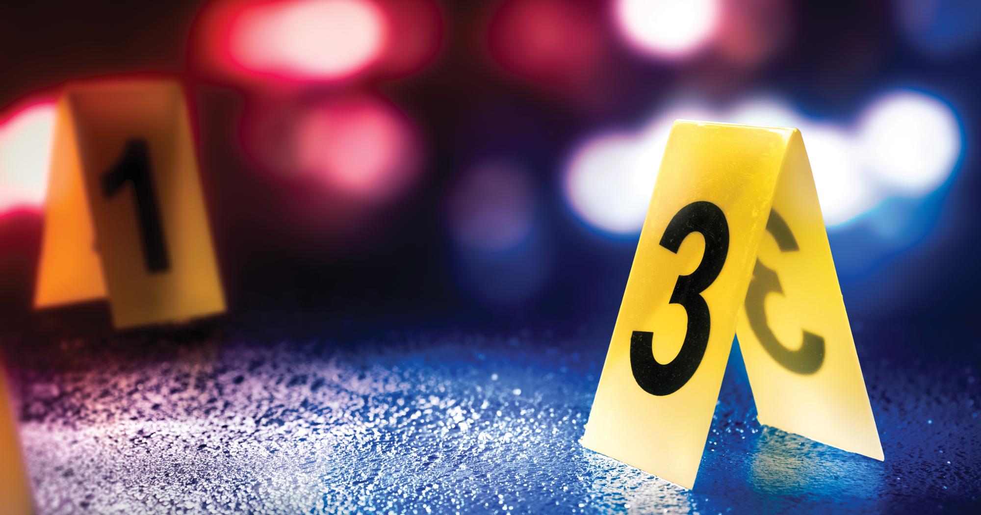 A yellow crime scene evidence marker with the numeral 3 printed on it