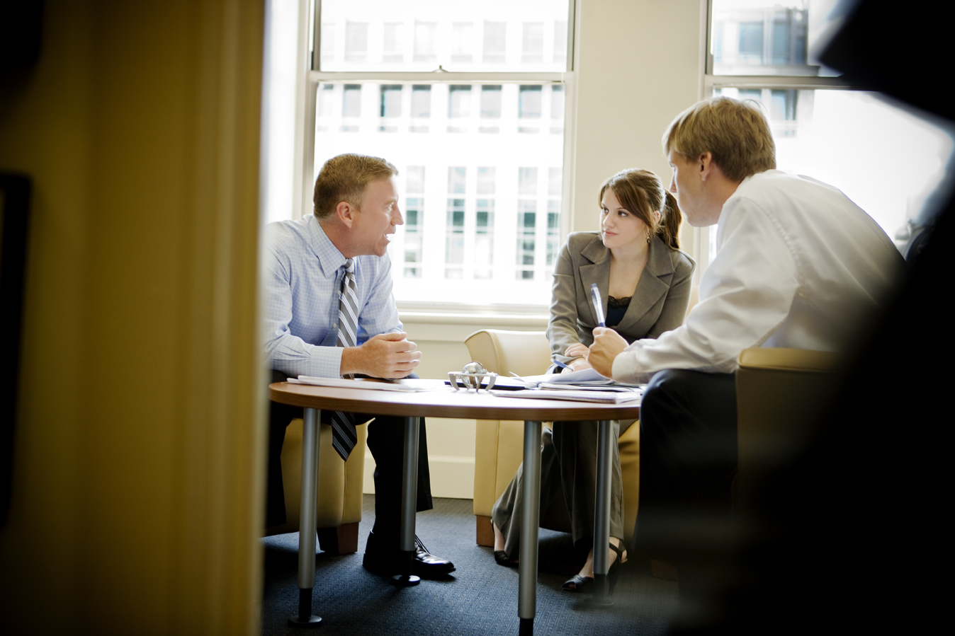 Office setting with staff member assisting students