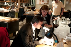 Representative John Holsclaw looking into microscope in Gray Fossil Site lab