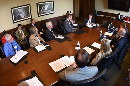 U.S. Food & Drug Administration Commissioner Robert M. Califf, MD, sits at  table talking with conference members.   