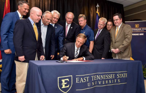 TN Governor Bill Haslam signs FOCUS Bill into law, accompanied by state legislators and ETSU President Brian Noland.