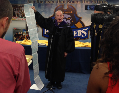 U.S. Senator Lamar Alexander holds up a FAFSA application