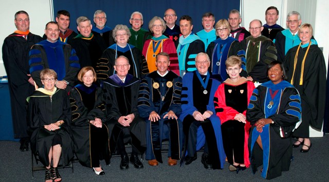 U.S. Senator Lamar Alexander sitting for photo with stage party members