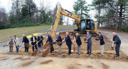 Local and ETSU leadership break ground with shovels on football stadium site.