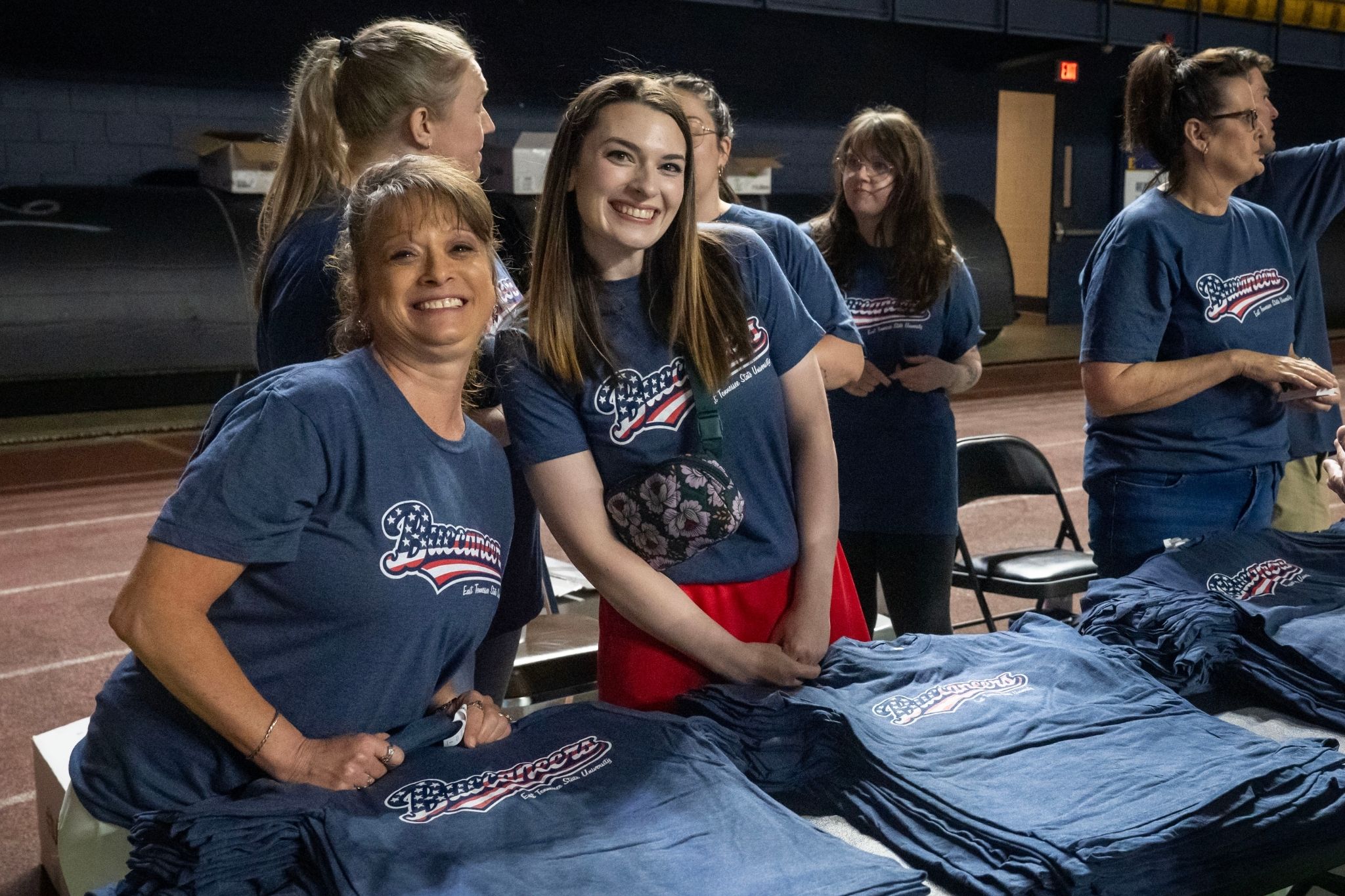 Volunteers help pass out shirts at the ETSU Staff Celebration.
